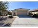 Charming single-story home featuring a two-car garage and a well-maintained xeriscaped front yard at 44583 W Windrose Dr, Maricopa, AZ 85138