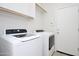 Laundry room area with white washer and dryer at 44583 W Windrose Dr, Maricopa, AZ 85138
