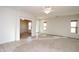Expansive living room featuring neutral paint, carpet and tile flooring, and plenty of natural light at 44583 W Windrose Dr, Maricopa, AZ 85138