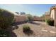 Spacious backyard featuring low-maintenance desert landscaping with decorative rock and stepping stones at 45071 W Yucca Ln, Maricopa, AZ 85139