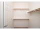 Walk-in closet with built in shelves and a door at 45071 W Yucca Ln, Maricopa, AZ 85139