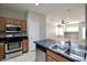The kitchen features stainless steel appliances, a breakfast bar, and ample cabinets at 45071 W Yucca Ln, Maricopa, AZ 85139