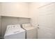 Laundry room with washer, dryer and overhead shelf at 45071 W Yucca Ln, Maricopa, AZ 85139