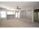 Expansive living room featuring neutral paint, carpet, and ceiling fans at 45071 W Yucca Ln, Maricopa, AZ 85139