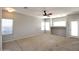 Spacious living room with neutral paint, carpet, and multiple windows for natural light at 45071 W Yucca Ln, Maricopa, AZ 85139