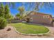 Scenic backyard featuring lush green grass and mature trees with privacy walls at 4552 E County Down Dr, Chandler, AZ 85249