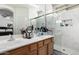 Modern bathroom features a dual sink vanity and a luxurious marble tiled walk-in shower at 4552 E County Down Dr, Chandler, AZ 85249