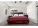 Well-lit bedroom with plush carpeting, a ceiling fan, and a large window offering ample light at 4552 E County Down Dr, Chandler, AZ 85249