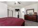 Relaxing bedroom featuring a large bed, dresser, TV, carpeted flooring, and neutral walls at 4552 E County Down Dr, Chandler, AZ 85249