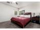 Comfortable bedroom with a ceiling fan, window, and carpeted flooring for relaxation at 4552 E County Down Dr, Chandler, AZ 85249