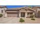 Charming single-story home featuring a well-manicured lawn, two-car garage and inviting entryway at 4552 E County Down Dr, Chandler, AZ 85249
