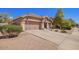 Charming single-story home featuring a well-manicured lawn, two-car garage and inviting entryway at 4552 E County Down Dr, Chandler, AZ 85249