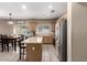 Well-lit kitchen boasts stainless steel appliances, an island, and an adjacent dining area at 4552 E County Down Dr, Chandler, AZ 85249