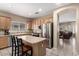 This kitchen includes stainless steel appliances, light wood cabinets, an island, and tile floors at 4552 E County Down Dr, Chandler, AZ 85249