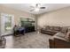 Inviting living room featuring a large aquarium, comfortable sectional sofa, and access to the outdoors at 4552 E County Down Dr, Chandler, AZ 85249