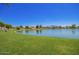 Picturesque lake surrounded by lush green grass and well-maintained landscaping at 4552 E County Down Dr, Chandler, AZ 85249