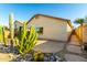 Backyard featuring desert landscaping, stone pathway, and low-maintenance design with a view of the home at 45564 W Sheridan Rd, Maricopa, AZ 85139