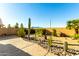 Desert landscaped backyard with native plants and stone accents, offering a tranquil and low-maintenance space at 45564 W Sheridan Rd, Maricopa, AZ 85139