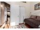 Bedroom with a daybed, complemented by convenient access to closets and nearby living areas at 45564 W Sheridan Rd, Maricopa, AZ 85139