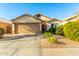 Inviting single-Gathering home with a well-manicured front yard and a two-car garage at 45564 W Sheridan Rd, Maricopa, AZ 85139