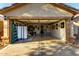 Open garage featuring organized storage racks, work benches, and ample space for vehicles at 45564 W Sheridan Rd, Maricopa, AZ 85139