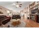 Spacious living room featuring hardwood floors, a ceiling fan, and natural light at 45564 W Sheridan Rd, Maricopa, AZ 85139