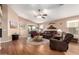 Comfortable living room featuring a ceiling fan and sliding glass doors to the patio at 45564 W Sheridan Rd, Maricopa, AZ 85139