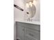 Stylish bathroom featuring a modern vanity with a white countertop, sleek fixtures, and a decorative mirror at 4940 E Grandview St, Mesa, AZ 85205