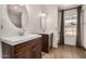 Charming bathroom with dual vanities, wood cabinets, and a window for natural light, creating a functional space at 4940 E Grandview St, Mesa, AZ 85205