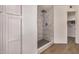 Modern bathroom showcasing a tiled shower with a rainfall shower head, creating a spa-like experience at 4940 E Grandview St, Mesa, AZ 85205