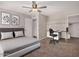 Bedroom with a ceiling fan, built-in shelving, and an adjacent workstation at 4940 E Grandview St, Mesa, AZ 85205