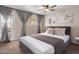 Bright bedroom featuring a ceiling fan, sliding glass doors, and neutral decor at 4940 E Grandview St, Mesa, AZ 85205