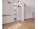 Bright dining room with modern chandelier, neutral color scheme and wooden floors at 4940 E Grandview St, Mesa, AZ 85205