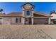 Charming home exterior with pillars, neutral color scheme, and a well-maintained front yard at 4940 E Grandview St, Mesa, AZ 85205