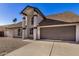 Charming home exterior with pillars, neutral color scheme, and a well-maintained front yard at 4940 E Grandview St, Mesa, AZ 85205