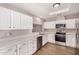 Bright kitchen featuring white cabinets, stainless steel appliances and wooden floors at 4940 E Grandview St, Mesa, AZ 85205