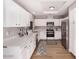 Modern kitchen featuring stainless steel appliances, white cabinets, and granite countertops at 4940 E Grandview St, Mesa, AZ 85205