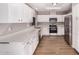 Bright kitchen featuring white cabinets, stainless steel appliances, and modern countertops, creating a clean and inviting space at 4940 E Grandview St, Mesa, AZ 85205