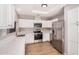 Bright kitchen featuring white cabinets, stainless steel appliances and wooden floors at 4940 E Grandview St, Mesa, AZ 85205
