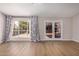 Well-lit living room showcasing large windows and French doors leading to outdoor views with natural light at 4940 E Grandview St, Mesa, AZ 85205
