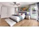 Relaxing bedroom with a poolside view, modern decor, and hardwood floors at 4940 E Grandview St, Mesa, AZ 85205
