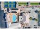 Aerial view showcasing tennis courts, a pool and solar panels at 520 S Greenfield Rd # 22, Mesa, AZ 85206
