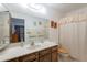 Bright bathroom with vanity, wood cabinets, a large mirror, and a shower with a curtain at 520 S Greenfield Rd # 22, Mesa, AZ 85206