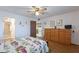 Bright bedroom with a ceiling fan, wood floors, and a glimpse into the adjacent kitchen area at 520 S Greenfield Rd # 22, Mesa, AZ 85206