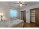 Charming bedroom featuring a ceiling fan, wood floors, and closet space with sliding doors at 520 S Greenfield Rd # 22, Mesa, AZ 85206