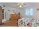 Comfortable bedroom with wood floors, a ceiling fan, and an open doorway view to another room at 520 S Greenfield Rd # 22, Mesa, AZ 85206
