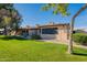 Well-maintained exterior with a green lawn, manicured bushes, and a clear blue sky backdrop at 520 S Greenfield Rd # 22, Mesa, AZ 85206