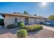 Charming single-story brick home with a well-manicured lawn, attached garage, and a sunny blue sky at 520 S Greenfield Rd # 22, Mesa, AZ 85206