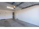 Spacious two car garage with painted white walls and ceiling storage at 520 S Greenfield Rd # 22, Mesa, AZ 85206