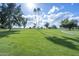 Expansive golf course view featuring lush green grass, mature trees, and a clear blue sky with scattered clouds at 520 S Greenfield Rd # 22, Mesa, AZ 85206
